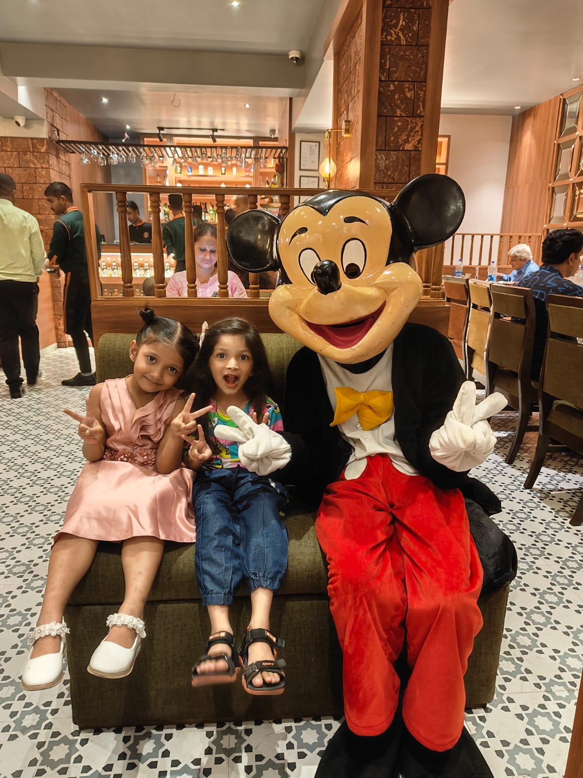 Child enjoying the Mickey Mouse mascot at a Toywala event